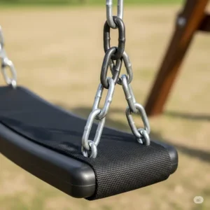 Close-up of a black, heavy-duty belt swing seat with thick, coated chains, designed for adult swing sets.