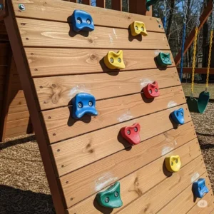 A detailed view of a rock climbing wall on a wooden swing set, a feature of our popular Black Friday swing set sale.