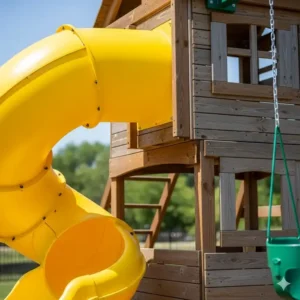 Close-up of a swing set clubhouse featuring a bright yellow twisting slide.