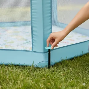 Image illustrating the ground stakes used to enhance the stability of the outdoor baby playpen on grass.