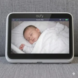 A hand holding the best baby monitor for travel portable to show its compact size.