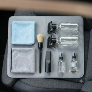 Essential detailing supplies and mild cleaning products gathered to show how to clean car seat safely without damage.